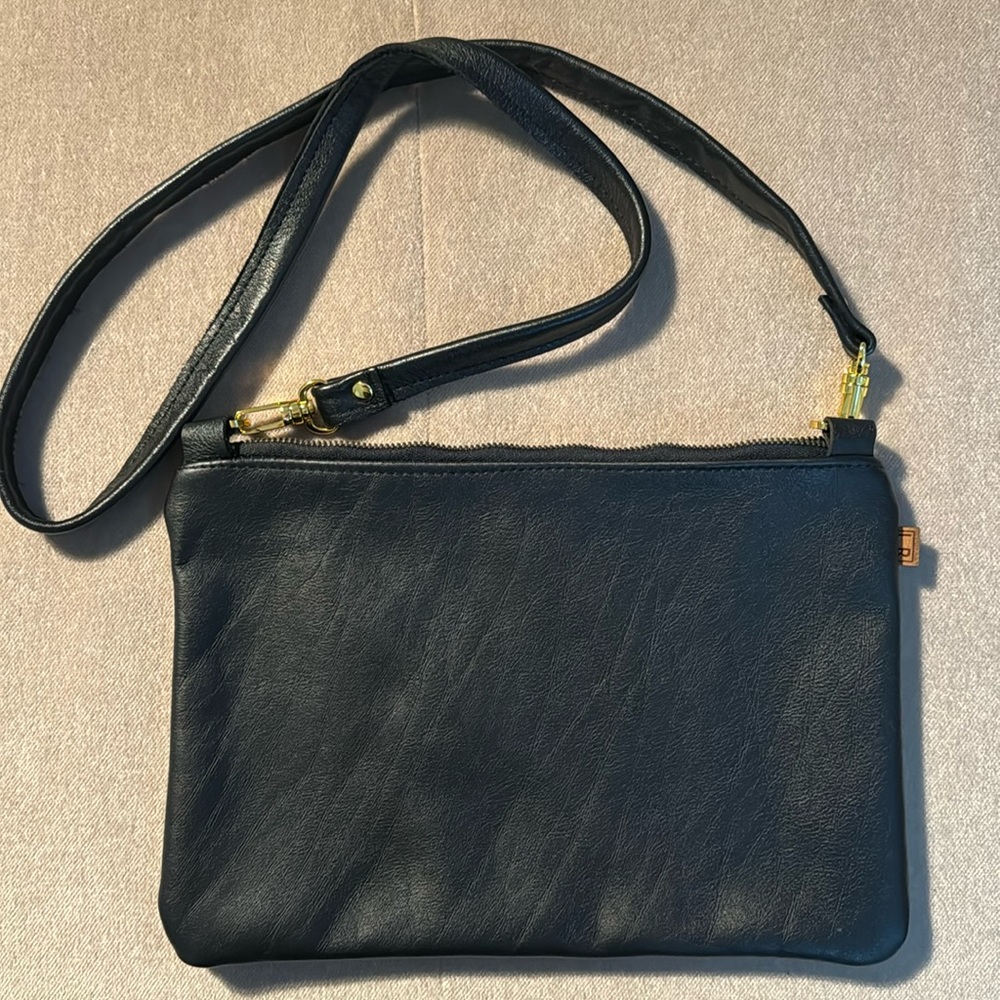 Cross body bag in black leather,11x8.   Strap is 22 “ long. New w/o tags.